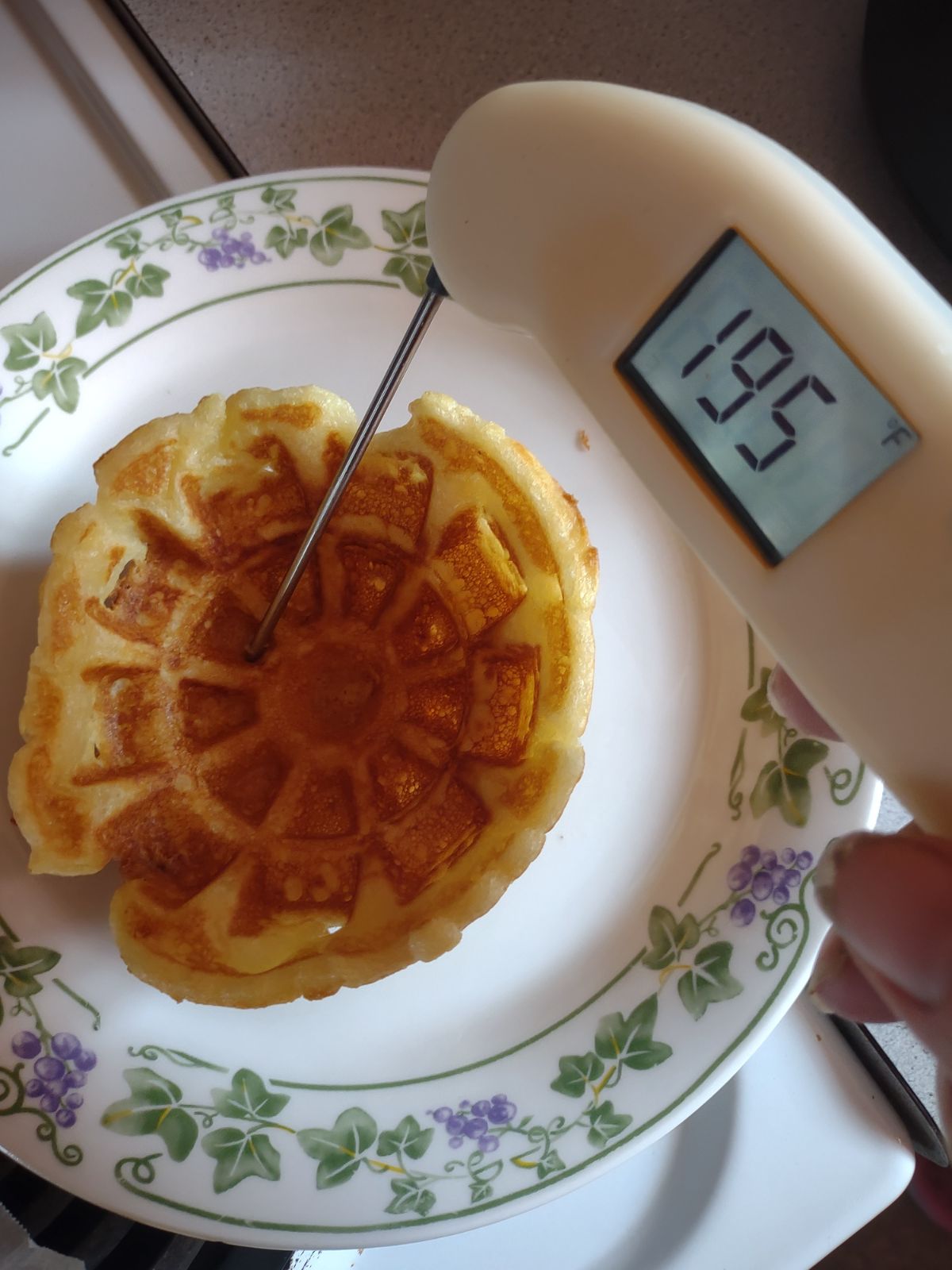 A Thermometer being used to check the temperature of a waffle bowl. The temperature was 195 degrees.