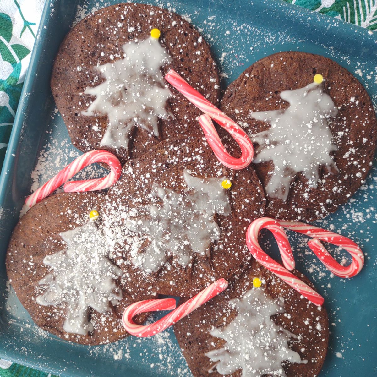 Christmas tree mini waffles with trees that have been decorated with a peppermint icing.
